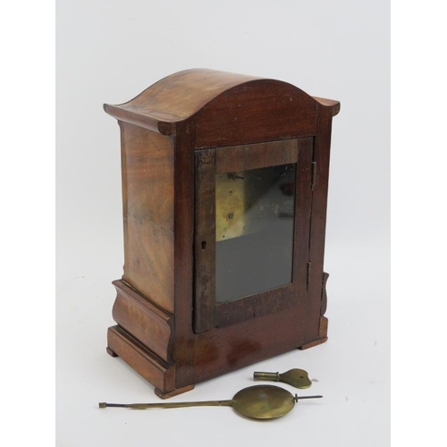 177 - A Victorian walnut mantle clock. White enamelled dial with Roman numerals. Key and pendulum included... 