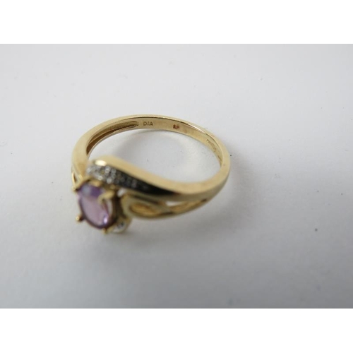 183 - A 9ct yellow gold diamond and amethyst ring. With a central claw set amethyst enclosed by an illusio... 