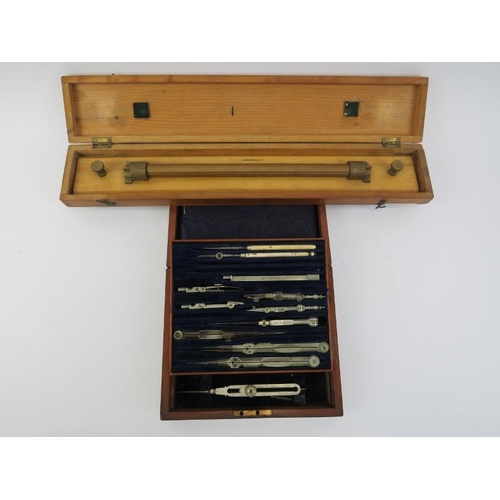 19 - Militaria: A vintage British Naval drawing set and parallel rolling rule. Both boxed, the drawing se... 