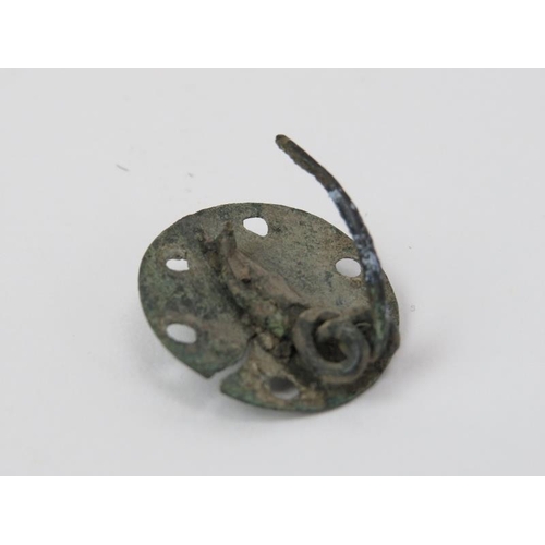 194 - A copper brooch of circular form with decorative pierced holes, possibly Celtic. 2.3 cm diameter.
Co... 