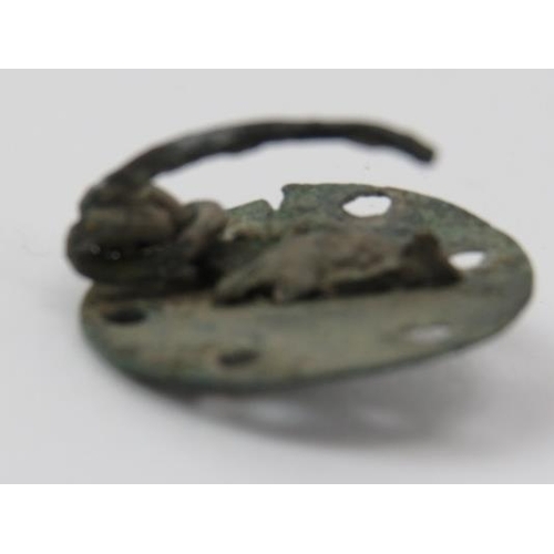 194 - A copper brooch of circular form with decorative pierced holes, possibly Celtic. 2.3 cm diameter.
Co... 