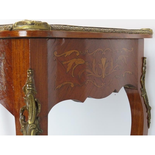 221 - A French 18th century style brass mounted marquetry inlaid tulip wood side table. With a gilt tooled... 