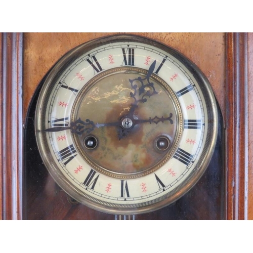 251 - A large mahogany wall clock, late 19th/early 20th century. Probably Austrian or German. Key and pend... 