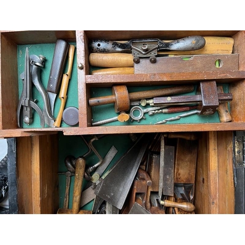 284 - A large black painted pine tool chest containing ship builders tools and related items. Including bl... 