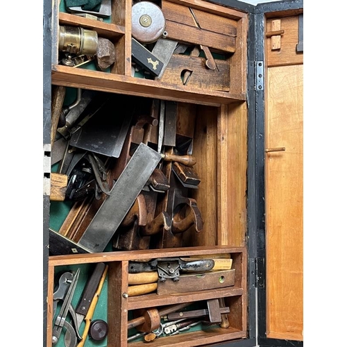 284 - A large black painted pine tool chest containing ship builders tools and related items. Including bl... 