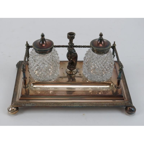 300 - Two Victorian silver plated desktop ink stands. Comprising an ink stand with square section inkwells... 