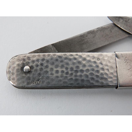 32 - A white metal spot hammered fruit knife, probably early 20th century. With unusual sliding double st... 