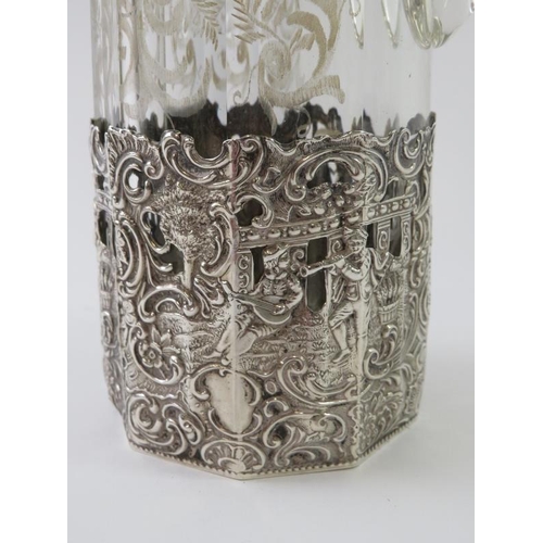 352 - A 19th century facet cut silver mounted decanter with wheel engraving to the body and repousse silve... 