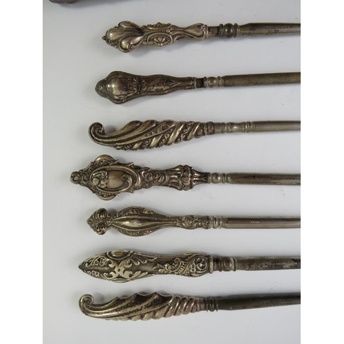 377 - A collection of silver mounted button hooks and shoe horns including Mr Punch and leopard's heads.