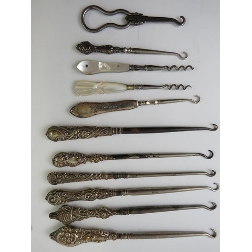 377 - A collection of silver mounted button hooks and shoe horns including Mr Punch and leopard's heads.