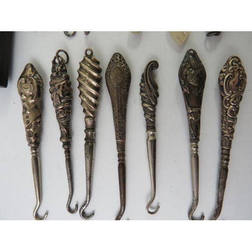 378 - A collection of silver mounted mainly 19th century glove button hooks including five folding example... 