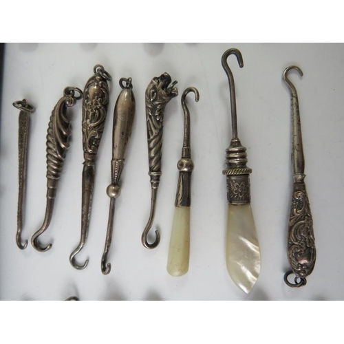 378 - A collection of silver mounted mainly 19th century glove button hooks including five folding example... 