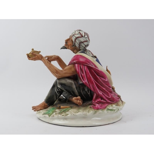 39 - A large Capodimonte figure of an Arabian merchant, 20th century. Naples factory mark to base. 24 cm ... 