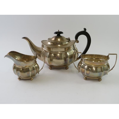 402 - A 1920s silver tea set comprising tea pot, sugar bowl and milk jug. Hallmarked for Birmingham 1921, ... 