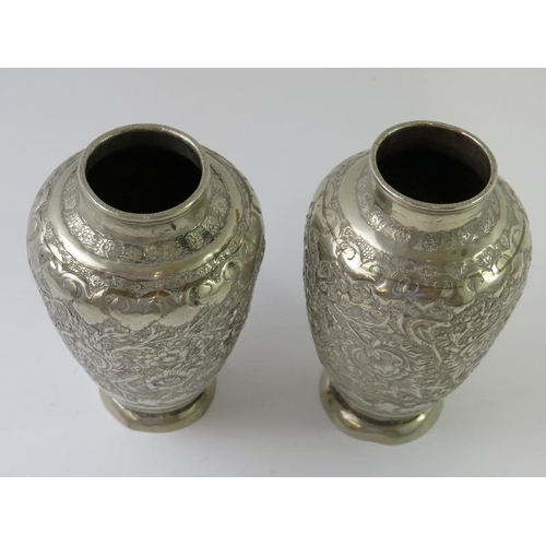 403 - A pair of Eastern white metal vases with chased decoration, height 11.5cm. Gross weight 230 grams