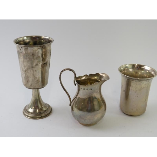 407 - A silver Jewish kiddush cup, marked .800, a silver beaker marked .800, and a small silver jug hallma... 