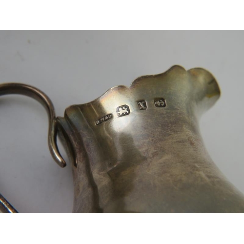 407 - A silver Jewish kiddush cup, marked .800, a silver beaker marked .800, and a small silver jug hallma... 