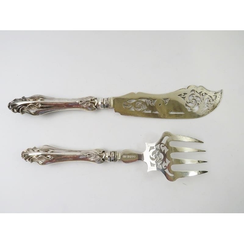 414 - A pair of ornate silver fish servers with pierced dolphin design to blade.  Hallmarked for Birmingha... 