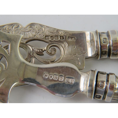 414 - A pair of ornate silver fish servers with pierced dolphin design to blade.  Hallmarked for Birmingha... 