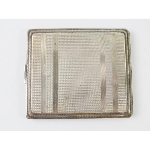 415 - A silver Art Deco revival cigarette case with engine turned decoration. Hallmarked for Birmingham 19... 