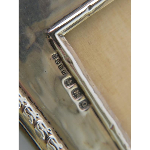 424 - An early 20th century silver photo frame, hallmarked for Birmingham 1913, maker Boots & Co, and a Fr... 