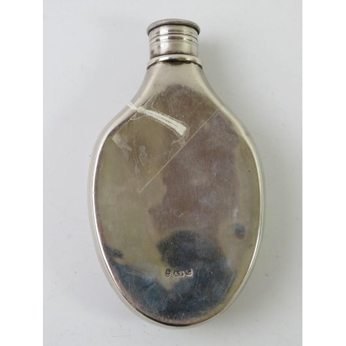 433 - A mid 19th century pebble shaped silver hip flask with engraved garter cartouche. Hallmarked for Bir... 