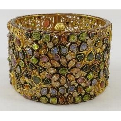 446 - A decorative 22ct gold Indian wide hinged bangle, of openwork design all over set with facet cut sem... 