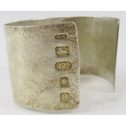 447 - A wide silver Artisanal cuff with textured finish, 4.2cm wide, 6.5cm diameter, feature hallmarks Lon... 