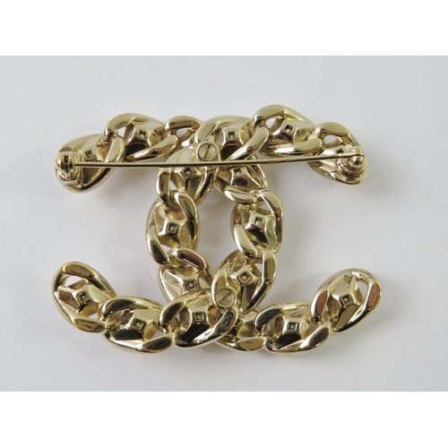 453 - CHANEL - a limited edition interlocking CC logo costume brooch of ‘woven’ design, with square-cut rh... 