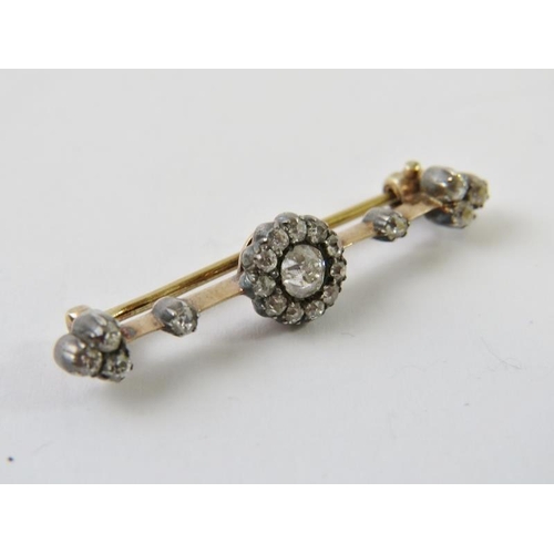 454 - A pretty late Victorian diamond set bar brooch, with central old cut diamond approx 0.25cts with a h... 