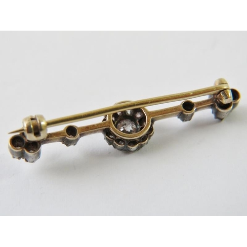 454 - A pretty late Victorian diamond set bar brooch, with central old cut diamond approx 0.25cts with a h... 