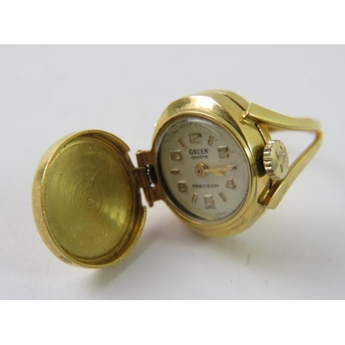 468 - An 18ct yellow gold novelty watch ring, the monogram engraved hinged circular lid opening to reveal ... 