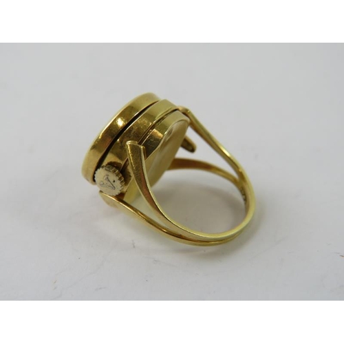 468 - An 18ct yellow gold novelty watch ring, the monogram engraved hinged circular lid opening to reveal ... 