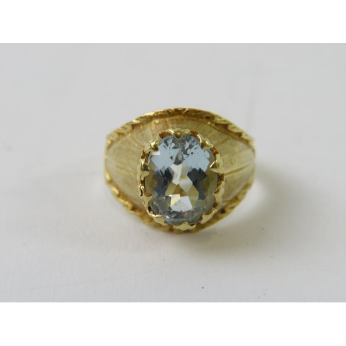 472 - A stylish retro aquamarine and precious yellow metal ring, the oval facet cut aquamarine in a raised... 