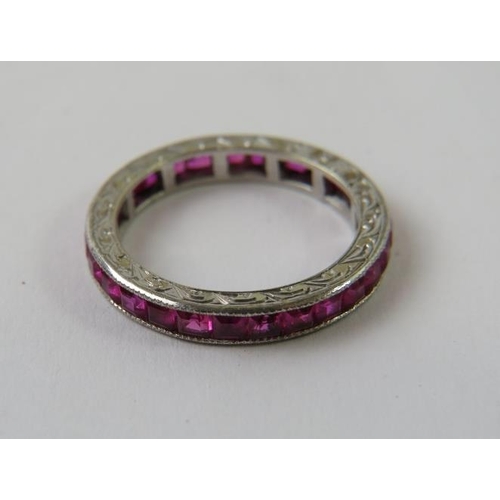 479 - A Platinum channel set calibre cut ruby full eternity ring, 2.5gms approx, 2.5mm depth,  with engrav... 