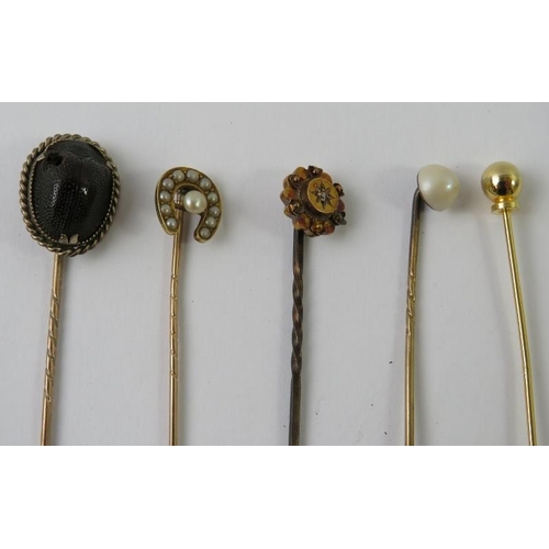 481 - A horseshoe and seed pearl stick pin, another similar set with a small diamond, and others to includ... 