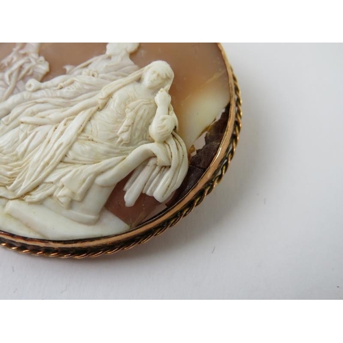 484 - A Victorian large oval carved shell cameo brooch, 57x 5mm depicting a classical figural scene in ros... 