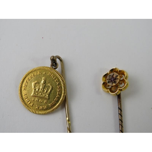 487 - A George III Third Guinea dated 1808 mounted as a stick pin; and another floral stick pin set with a... 