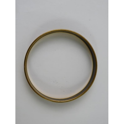 488 - HERMES: A  narrow belt printed enamel and yellow metal plated circular bangle 71mm diameter x 10mm h... 