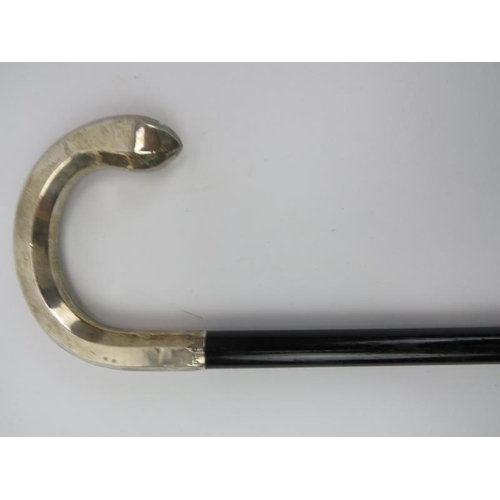 60 - An Edwardian ebonised walking cane with silver shepherd's crook handle. With a faceted handle, taper... 