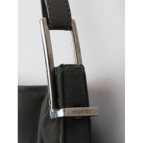 69 - A Gucci nylon shoulder bag. 37 cm length.
Condition report: Some age related wear.