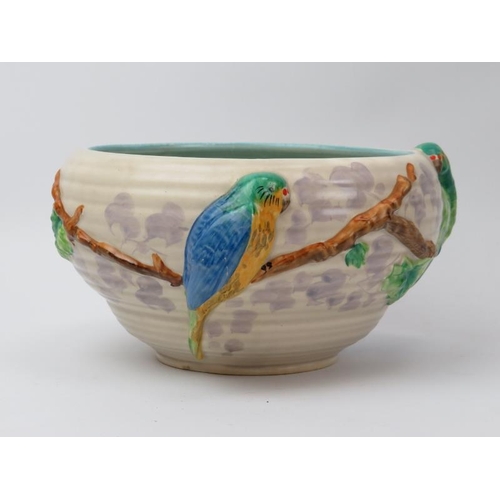 81 - A Clarice Cliff for Newport pottery bowl. Decorated in relief depicting brightly coloured parrots. I... 