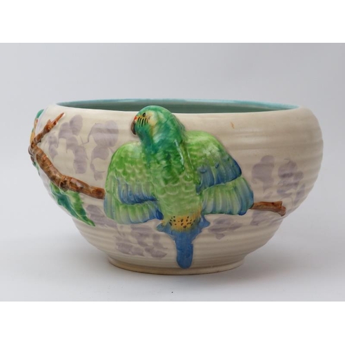 81 - A Clarice Cliff for Newport pottery bowl. Decorated in relief depicting brightly coloured parrots. I... 