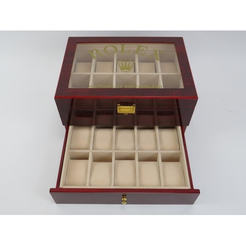 83 - A ‘Rolex Watches of Switzerland’ style presidential watch box. Compartmented for holding twenty watc... 