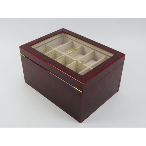 83 - A ‘Rolex Watches of Switzerland’ style presidential watch box. Compartmented for holding twenty watc... 