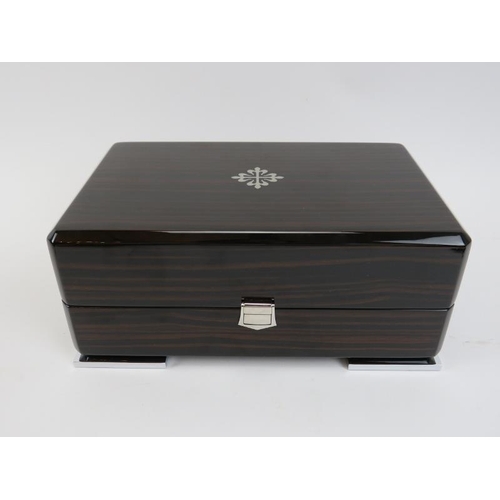 84 - A Patek Philippe wristwatch box. With fitted fabric lined interior, outer box and leather paperwork ... 