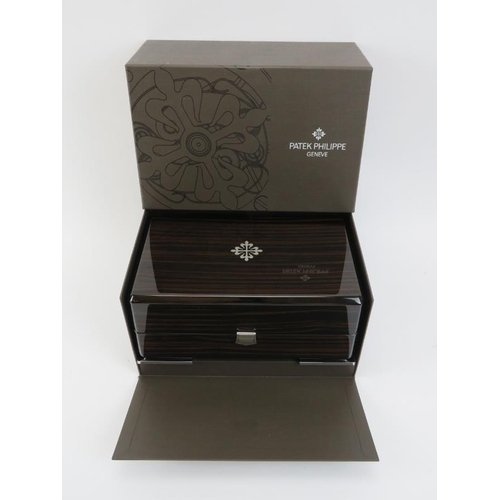 84 - A Patek Philippe wristwatch box. With fitted fabric lined interior, outer box and leather paperwork ... 