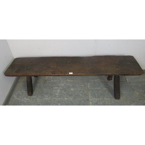 701 - A large 18th Century oak pig bench, on canted square supports.  Height 41cm x Width 158cm x Depth 44... 