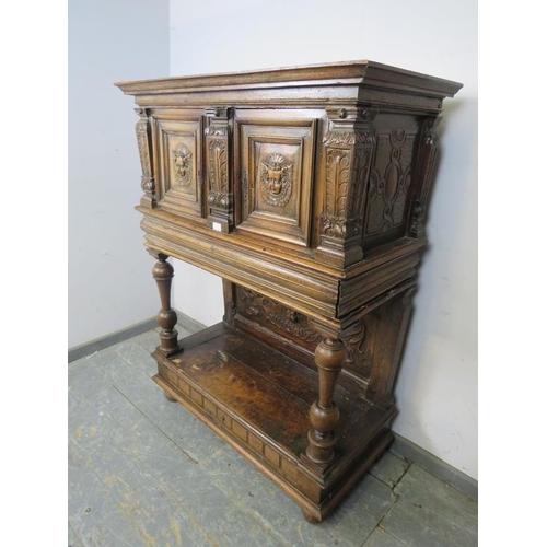 702 - A late 17th/early 18th century Continental fruitwood buffet cabinet, the twin doors carved with Putt... 