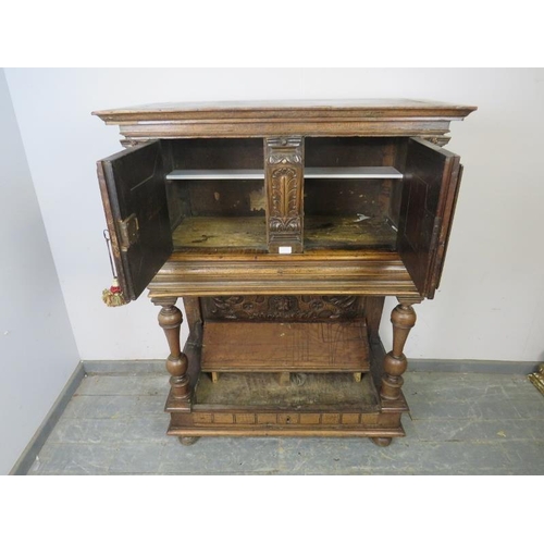 702 - A late 17th/early 18th century Continental fruitwood buffet cabinet, the twin doors carved with Putt... 